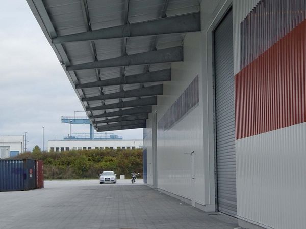 Außenansicht der neu gebauten Lagerhalle mit Blick auf den Dachüberstand